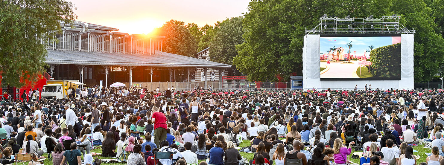Visitors enjoying a film under the stars on a summer evening in Paris